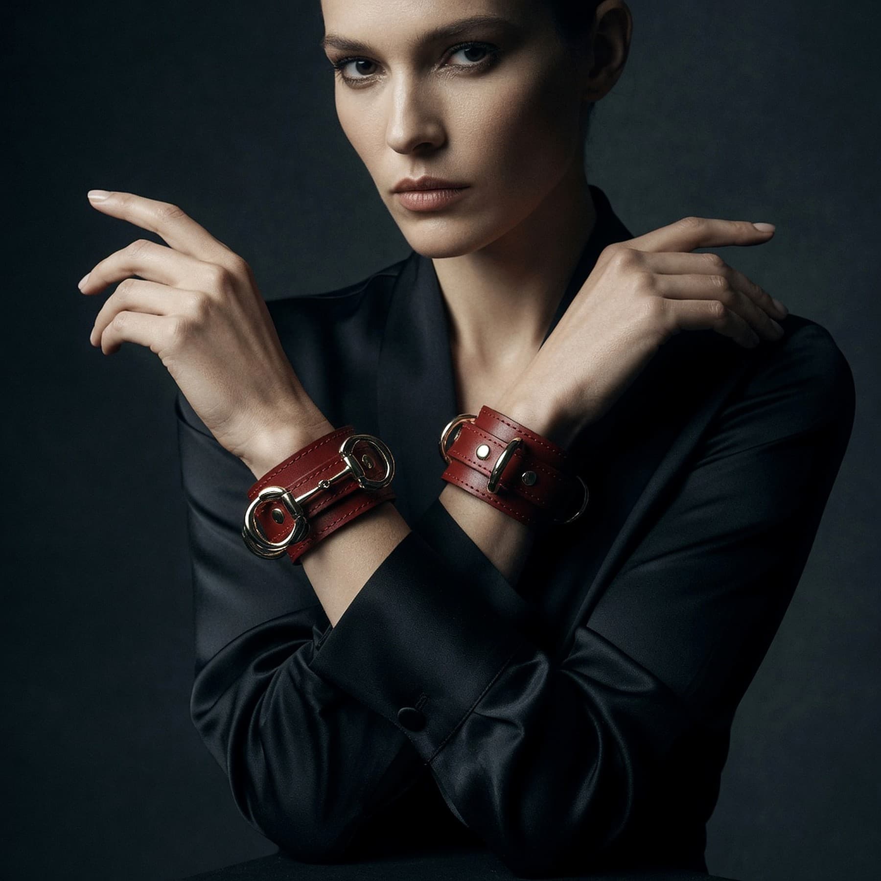 Full-grain black leather cuffs for play, solid brass hardware